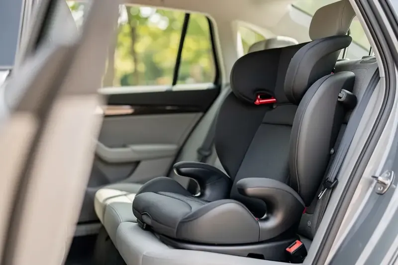 Kindersitzerhöhung mit Rückenlehne und Isofix auf der Rückbank eines Autos